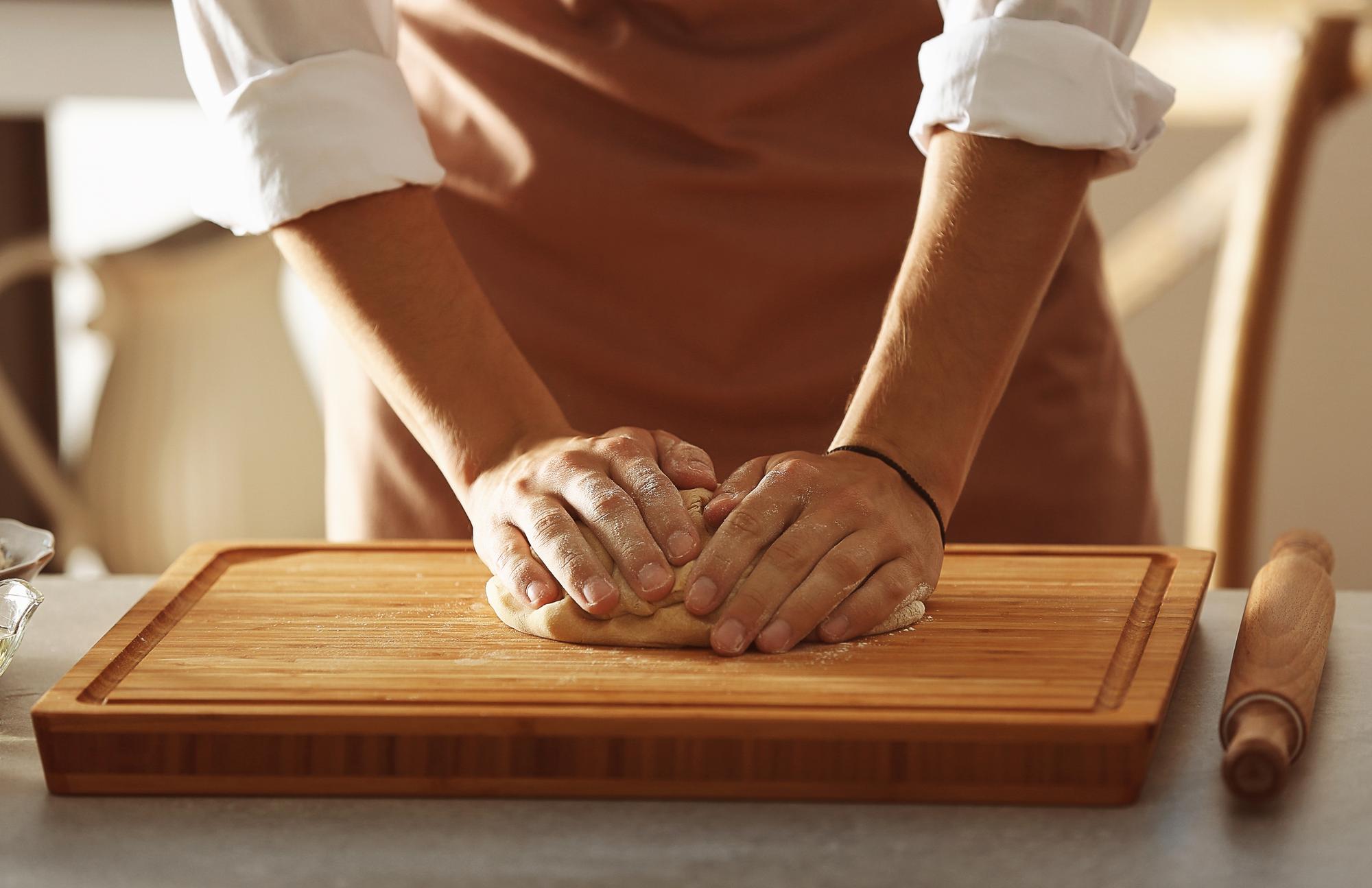 Artisan baking hands shaping dough